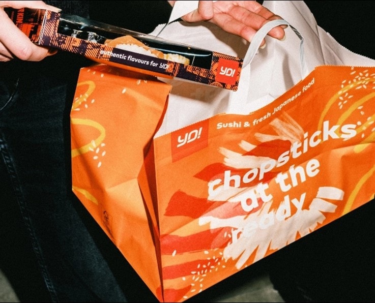 YO! sushi franchise partner placing sushi in a bag
